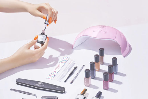 A nail tech applying Unigel gel polish with a brush